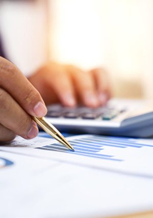 man with pen, calculator, and chart